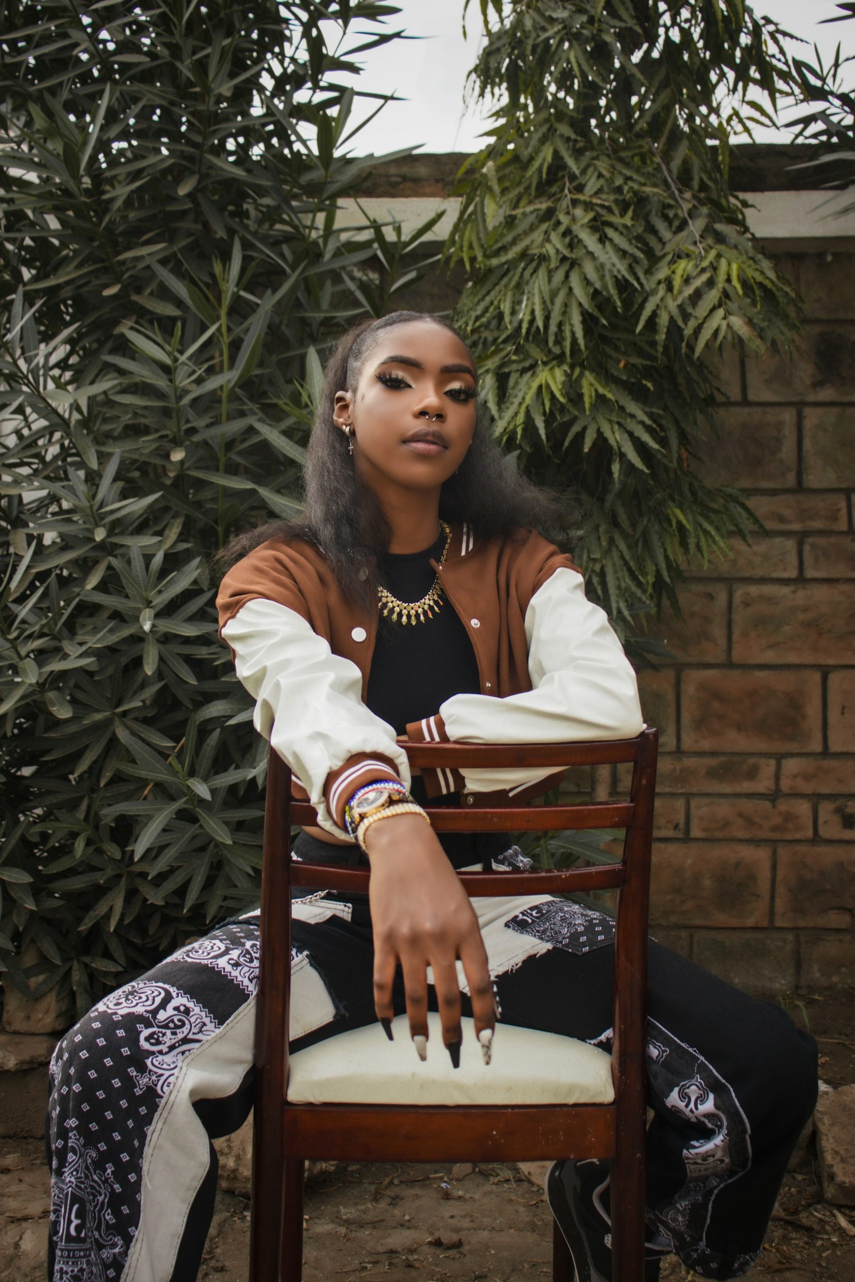 a woman sitting on top of a wooden chair